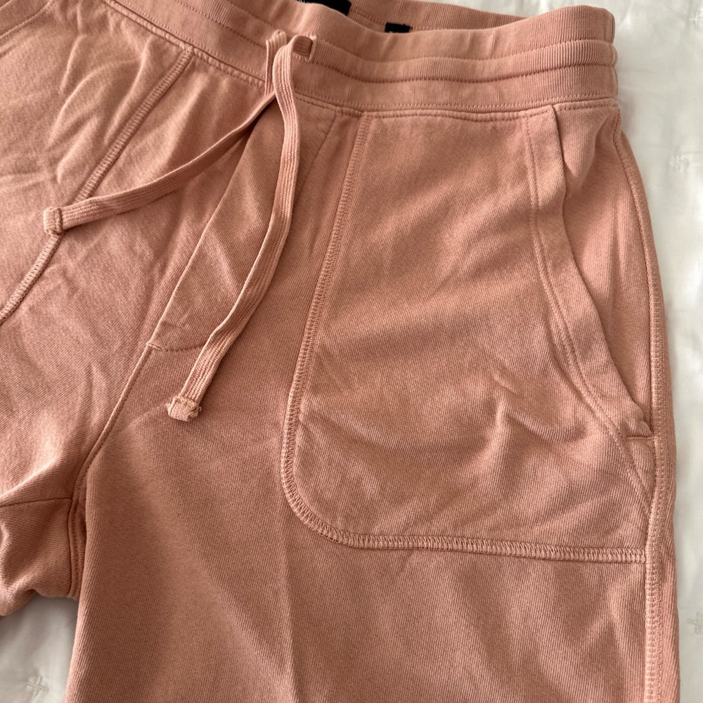 Men’s Vince drawstring shorts in a peachy color.